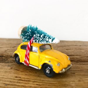 Vintage VW Beetle diecast car with bottle brush tree