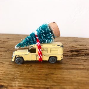 Adorable little vintage toy ambulance with bottle brush tree