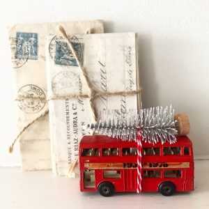 Charmingly shabby vintage toy bus with bottle brush tree