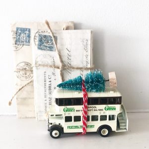 Vintage advertising bus with bottle brush tree